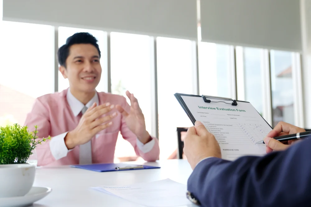 Man browsing laptop – freelancer or remote worker, a candidate in interview