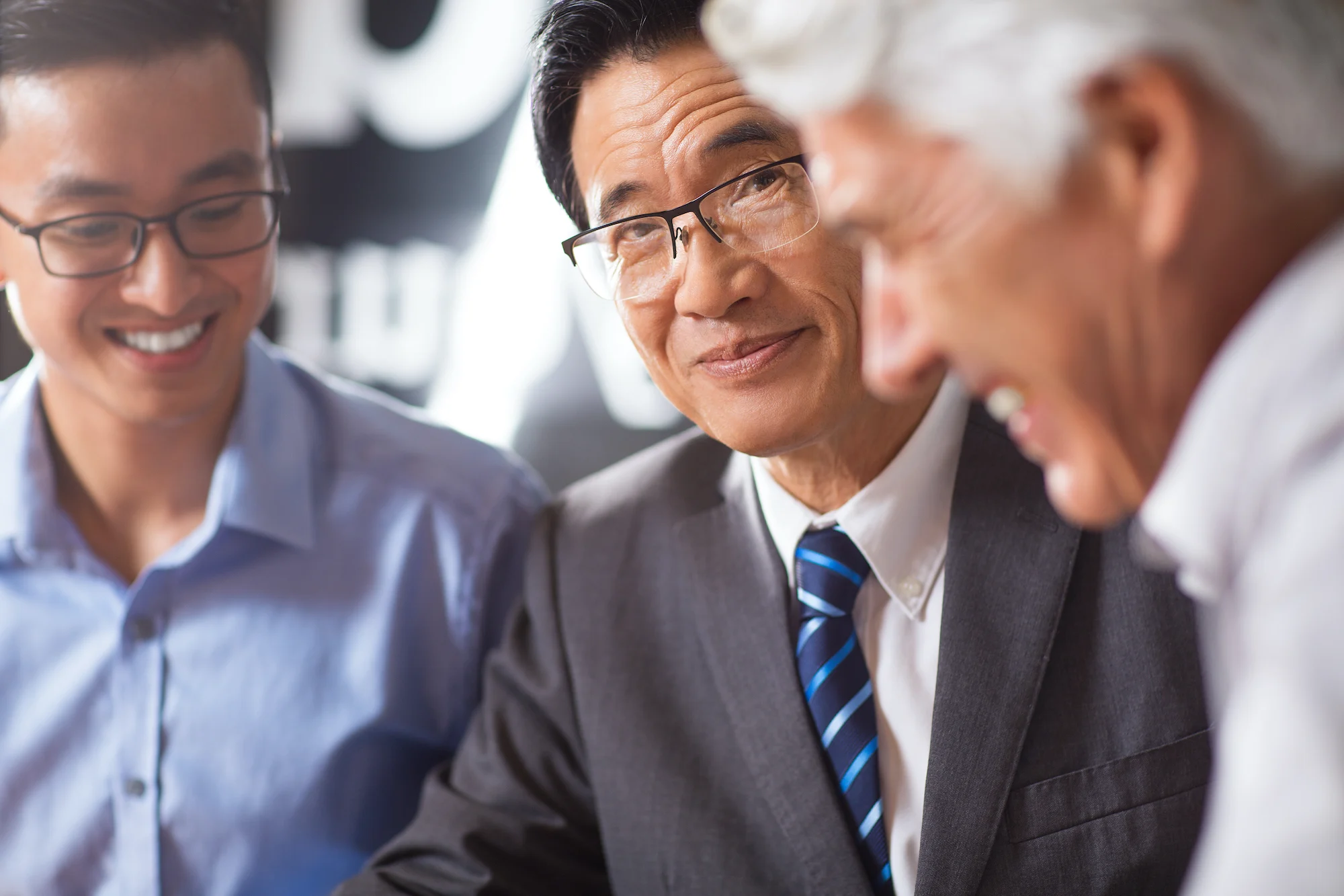 a group of older men having work discussion