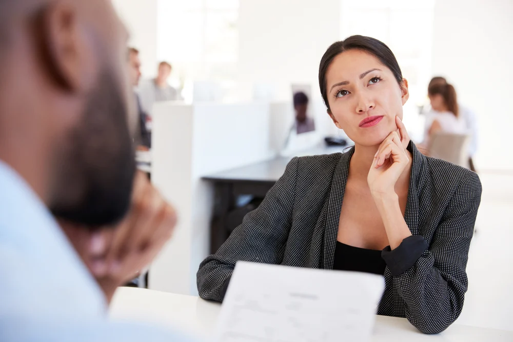 woman thinking during interview about the questions to ask