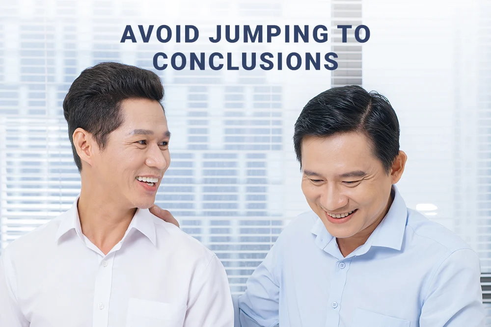 A male employee giving his colleague a pat on the back for assurance