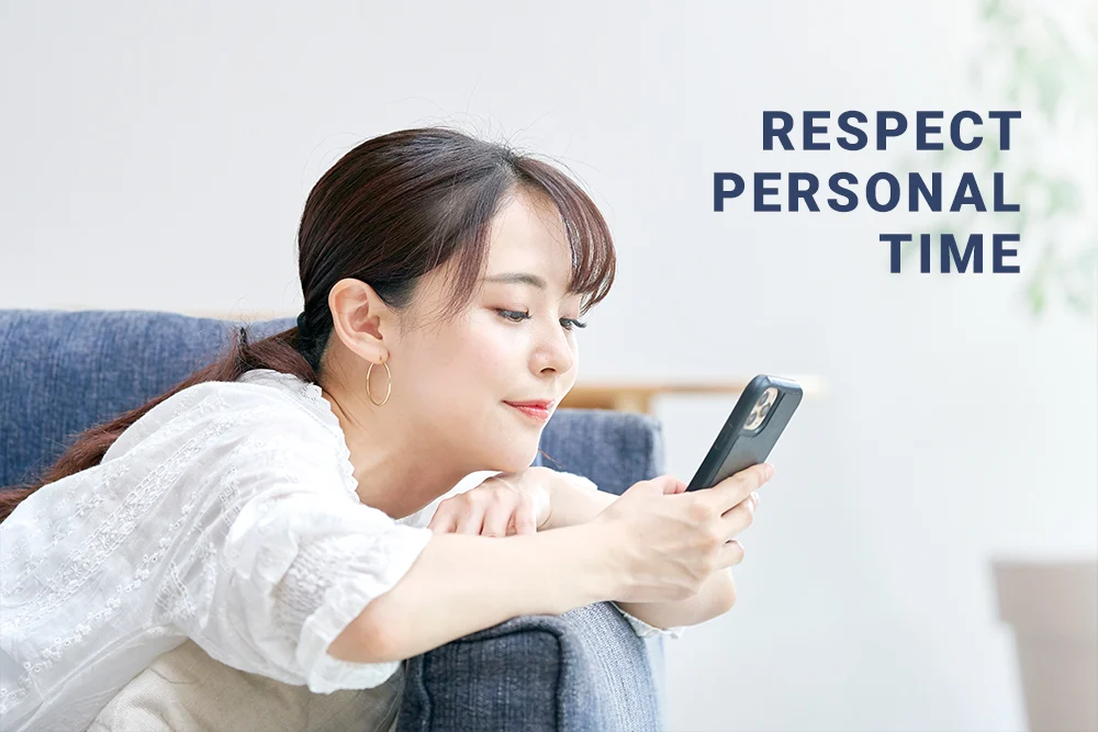 A lady leaning her head on the couch, while reading on the phone, respecting personal time