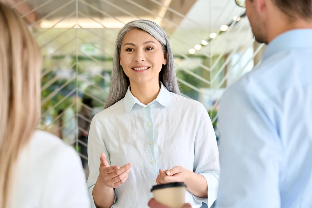 a woman conversing with her two colleagues