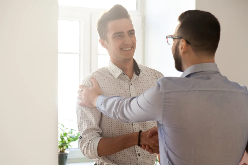 boss shaking employee's hand, email sample to thank colleagues for support