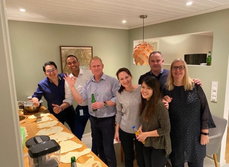 Minting (second from the right), with her colleagues learning to make pizzas from scratch at her manager’s place in Norway, Oslo.