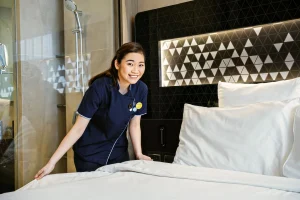 Katherine Ong performing housekeeping in a hotel room