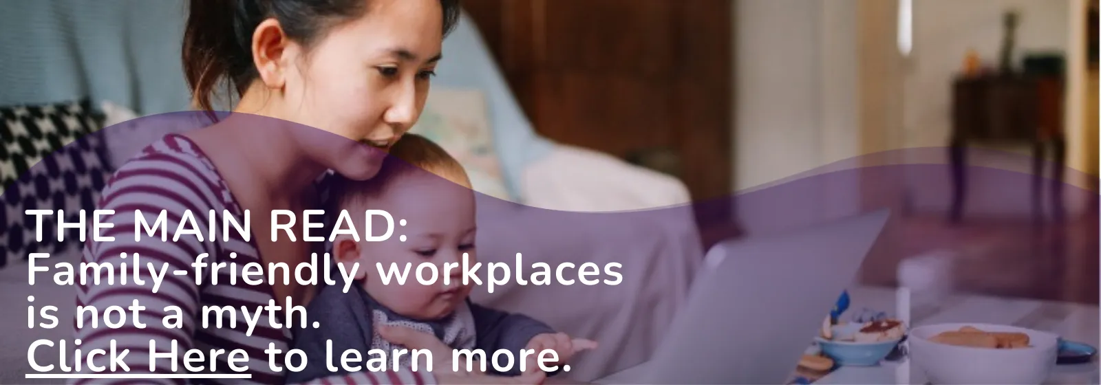 Mother carrying baby while working from home
