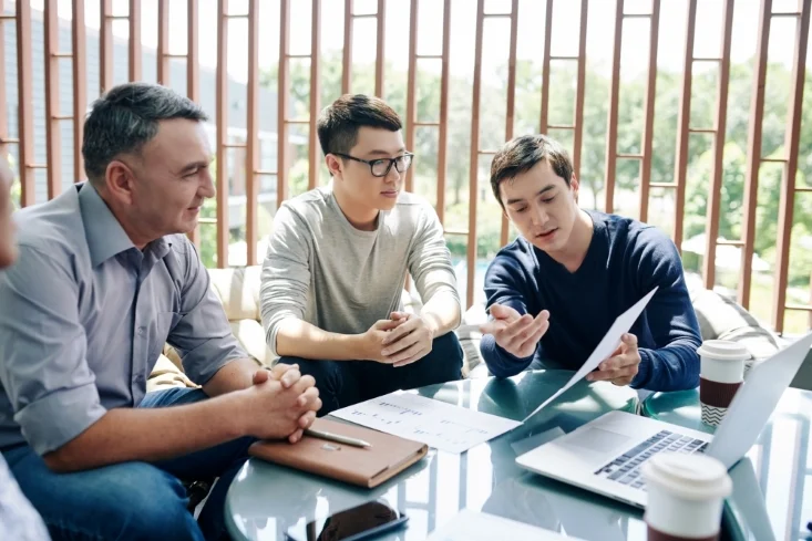a young worker presenting to his colleagues or customers