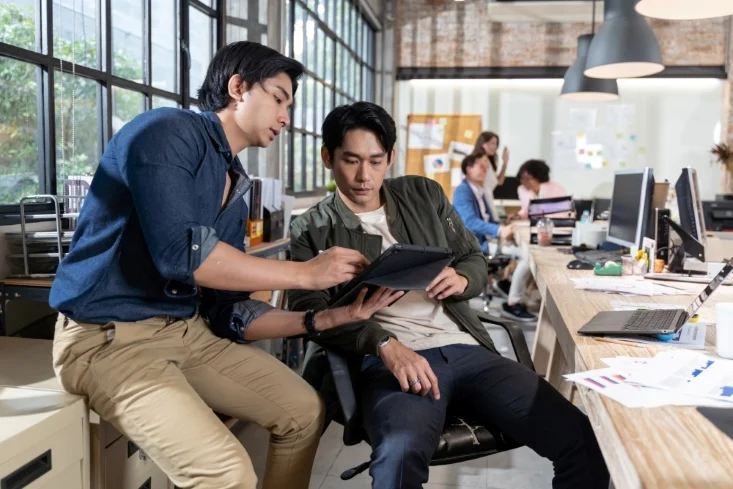 a man discussing work with his colleague