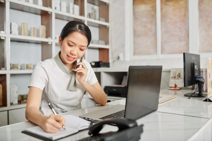 receptionist at the beauty centre, a woman answering call