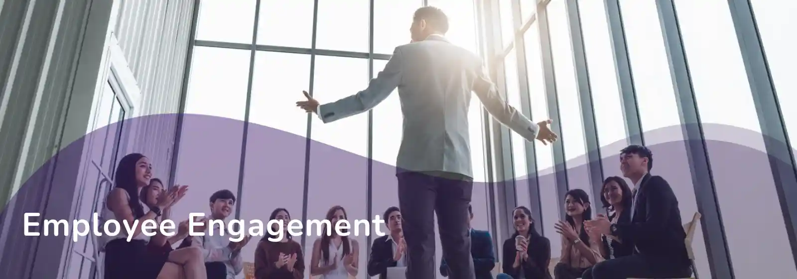 someone addressing in front of a group of people - employee engagement banner