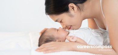 mother kissing her baby while on maternity leave