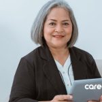 professional older woman holds a tablet