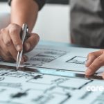 man working on architectural plans