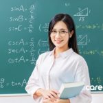 a teacher standing in front of a blackboard covered in mathematical equations