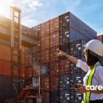 woman pointing at shipping containers