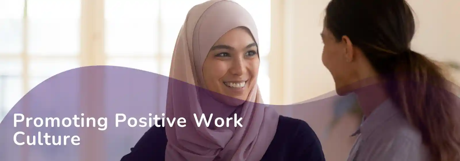 Business leadership concept graphic - Promoting positive work culture - 2 women talking, one wearing a hijab