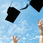 hands throwing up graduation caps