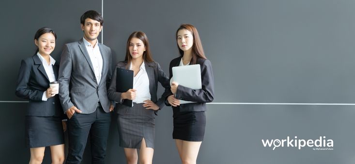 Four office workers standing in a row
