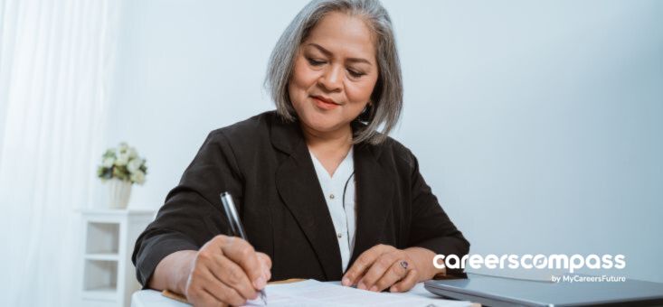 A woman writing on a paper