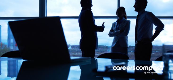 Three colleagues sharing a conversation