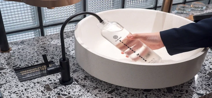 glass of filtered water on wooden table