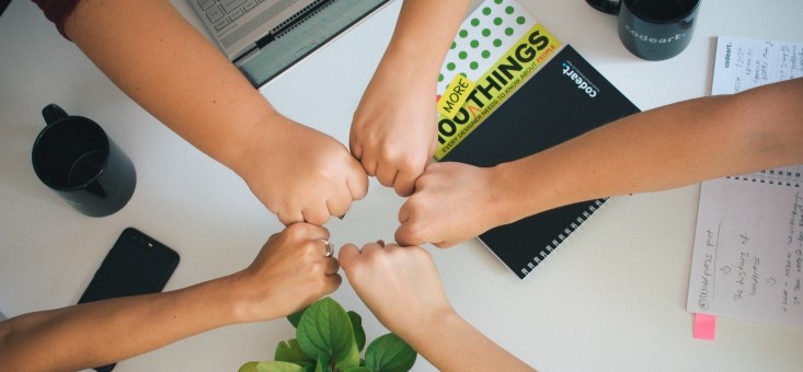 Colleagues fist bump each other