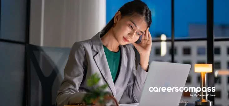 Asian woman in office dealing with sudden job loss and contemplating next move