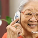 Retired senior worker looking to re-enter the workforce by searching for a job using her phone to make a call