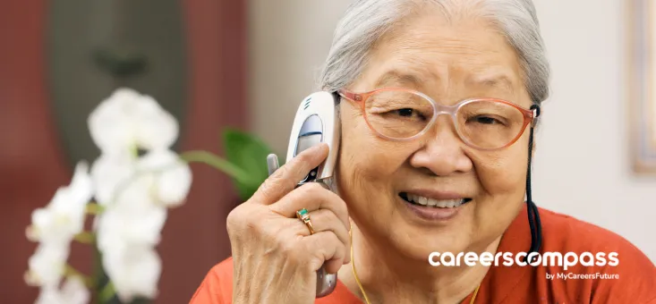 Retired senior worker looking to re-enter the workforce by searching for a job using her phone to make a call