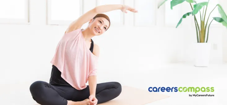 Asian woman doing sitting stretches on Yoga mat