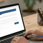 Asian woman typing out job application email on laptop in her home office