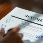 Entry-level candidate reviewing resume on table