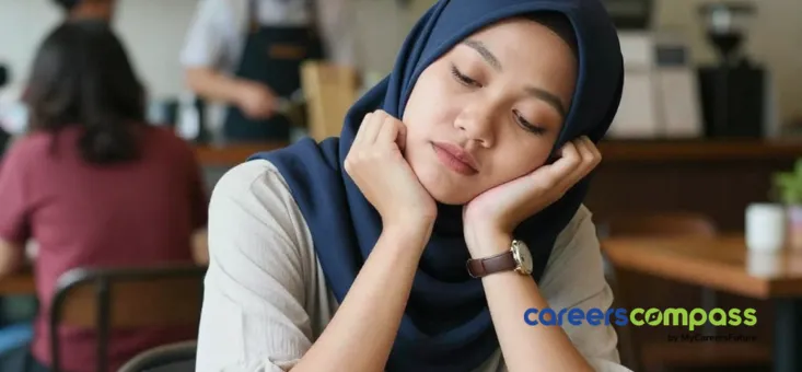 Malay woman wearing tudong looking tired while working in a cafe depicting Lazy Girl Jobs