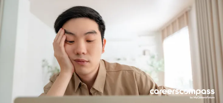 Young Asian man looking tired while working in Lazy Boy job
